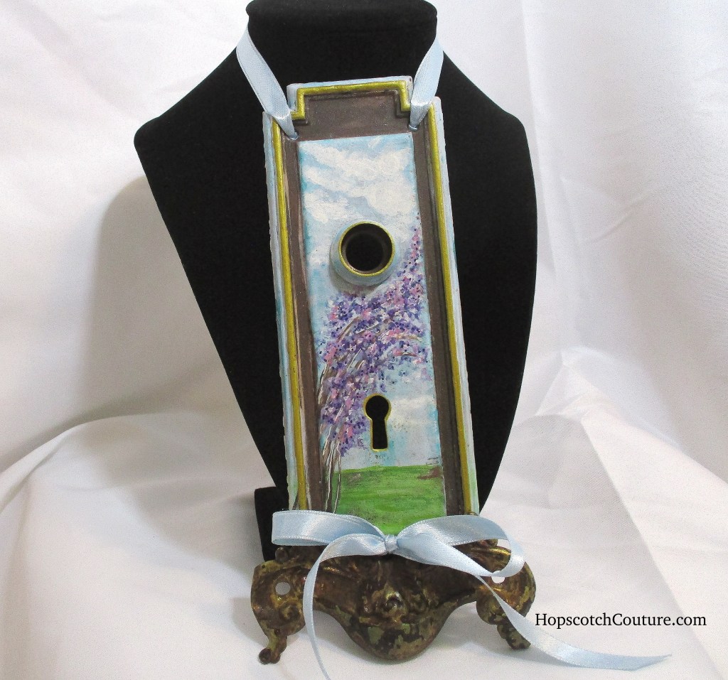 hand Painted lilac key hole pendant. Made with antique hardware and hand painted by Marelle Couture for Hopscotch Couture. https://hopscotchcouture.com/products/lavender-gardens-key-hole-pendant-ooak-fine-art-necklace?_pos=1&_psq=laven&_ss=e&_v=1.0 #hanmadependant #pendantnecklace #statementpendant #keyholenecklace