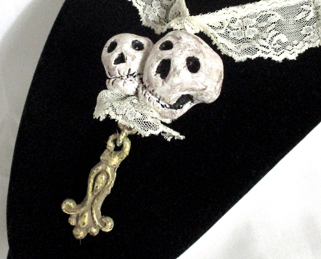 Close up of Handmade skeleton, skull pendant necklace by Marelle Couture for Hopscotch Couture https://hopscotchcouture.com/products/romantic-skulls-pendant-pendentif-crane-skeleton-necklace-a-couple-of-snuggly-skulls-jewelry-ooak?_pos=1&_psq=twin&_ss=e&_v=1.0 #skullnecklace #skeletonnecklace #skullsnecklace