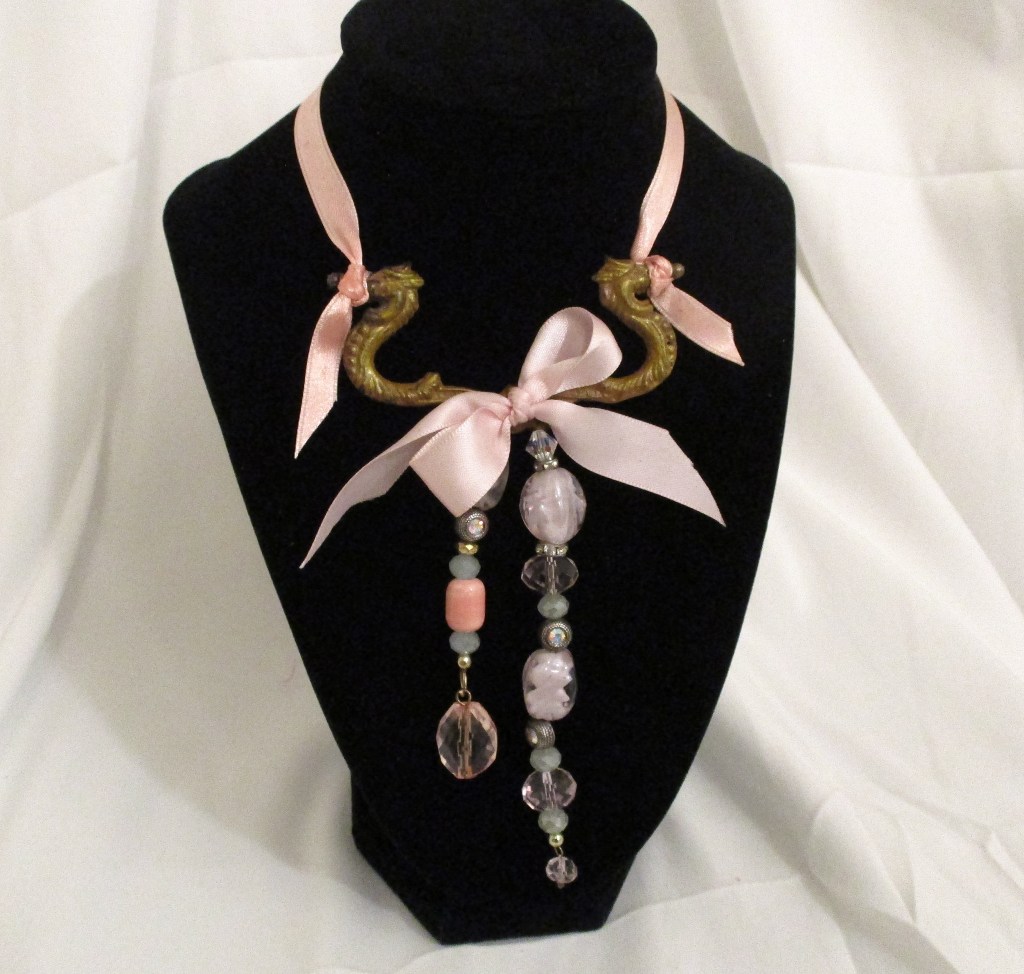 Closeup of pink glass beaded necklace made by Marelle Couture for Hopscotch Couture. https://hopscotchcouture.com/products/pink-dangle-necklace-glass-beaded-bridal-necklace-unique-upcycle-statement-pendant-romantic-victorian-jewellery-bijoux-rose-romantique?_pos=2&_sid=03bf9b8ba&_ss=r #Glassbeadednecklace #statementnecklace #pinknecklace