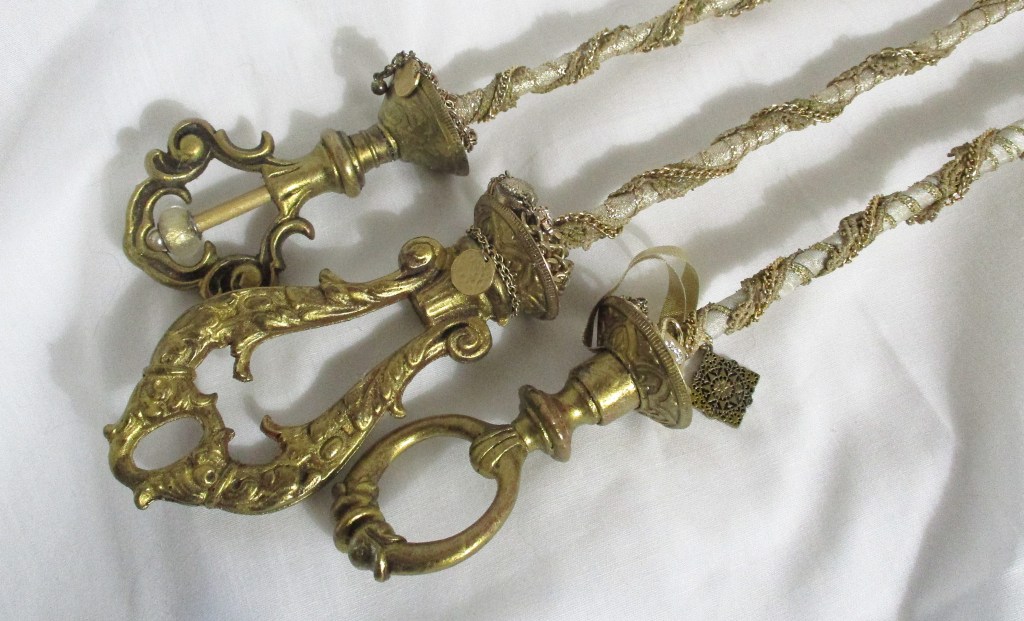 Close up of golden magic wands made by Marelle Couture for Hopscotch Couture.  https://hopscotchcouture.com/products/royal-wand-golden-scepter-baguette-royale-sceptre-d-or-costume-n-ceremony-ooak-royal-accessory?_pos=1&_psq=wands&_ss=e&_v=1.0 #royalwands #magicwands #goldenscepters #wands 